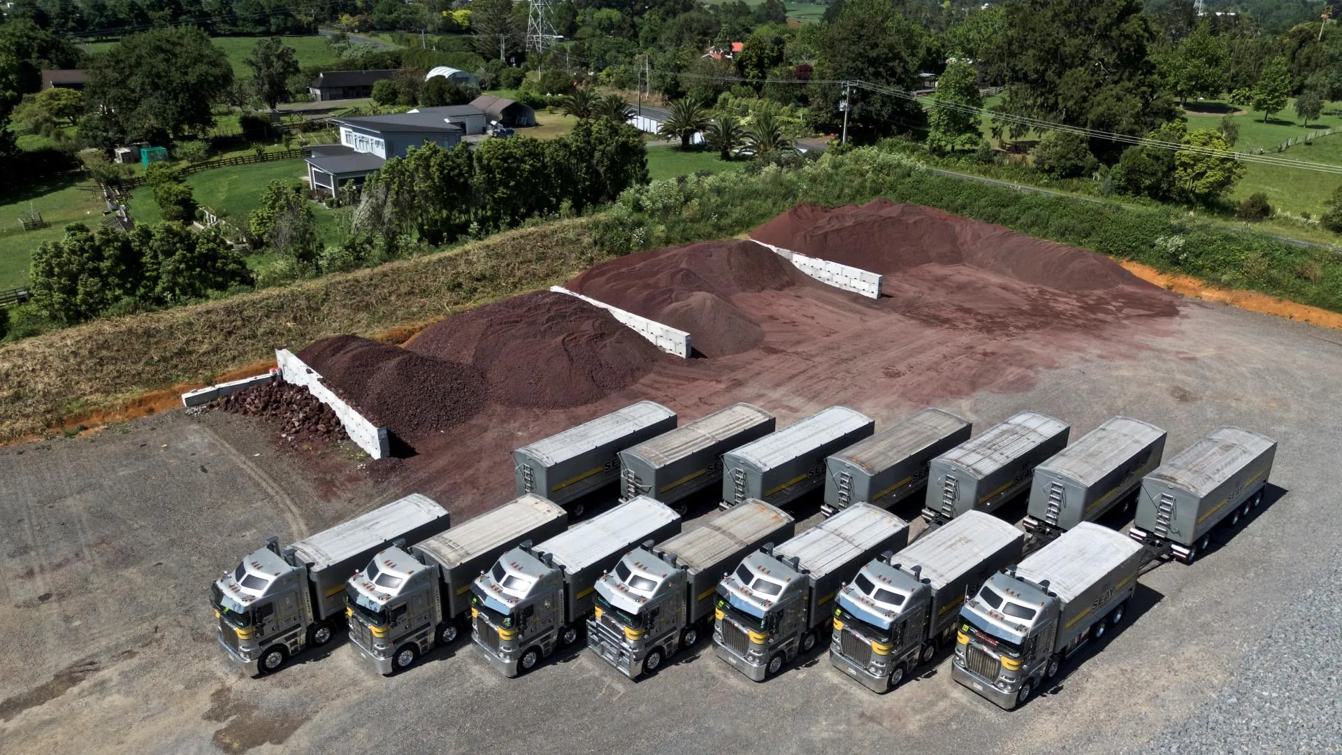 Aerial view of the Seay Distribution fleet beside scoria stockpiles